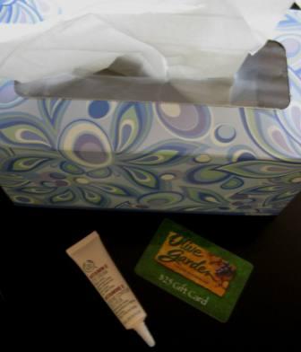 photo of kleenex box, eye cream, and restaurant gift certificate